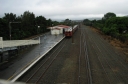 Looking north from the southern foot bridge of Woburn station. An old-style suburban train has pulled into the station.