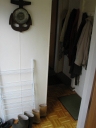 The back passageway, showing gumboots, coats, and a weather vane.