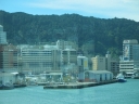 Looking out from Te Papa further north. The Beehive building can be seen on the right. The green building at the bottom centre is the Dockside restaurant. On the far right with Gandalf on the side is the New Zealand Post building. Reflections off the window are more obvious this time, showing the houses around Oriental Bay.