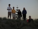 Mauricio, Iain, Shami, and Denise look out towards the sunset, while Snaiet appears from behind a sand dune.