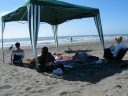 Mauricio, Snaiet, Denise, Haydn, and Jann continue to enjoy the afternoon under a gazebo at Peka Peka beach.
