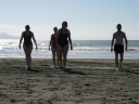 Snaiet, Jann, Denise, and Haydn head up the beach towards dry towels.