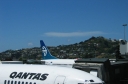 A view from the international departure lounge at Wellington Airport. The Qantas 737 in the foreground is the one I flew back to Sydney. The hills in the background are part of Mirimar.