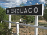 'Michelago' station board, with a picnic area behind the platform.