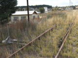 Looking northwest, we see disused points, overgrown track and the town in the distance.