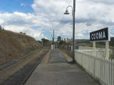 The southern end of Cooma platform, with tracks, platform, and signage.