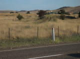Looking south across the Cooma highway into Bredbo, the line leading up to the highway is still visible.