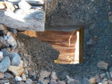 A view through a decking hole on Guises Creek bridge.