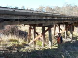 Erik poses next to the Guises Creek bridge, as the camera looks down the line.