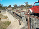 The eastern wall of the concrete bridge at the southern end of Williamsdale yard, looking down the line.