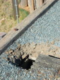 A hole in the decking of the road bridge at the up end of Michelago yard.