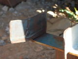 The bracket at the bottom of the carriage shed, holding the door in place, shows signs of wear.