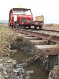 Scouring of the track base and remaining flood water, on the down side of the railway line, near 343.4km.