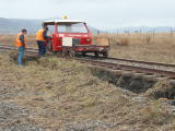 Scouring of the track base and vegetation, and ballast, on the down side of the railway line, near 343.4km.