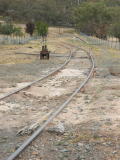 Overview of the new layer of topsoil at Tuggeranong Siding, looking down the line.