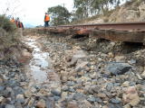 Exposed sleepers and flood water looking up the line towards the Tuggeranong valley, near 341.8km.