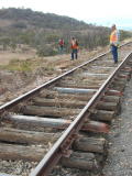 Several sleepers stand suspended from the railway line, as flood water has washed away much of the ballast, near 341.7km.