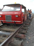 Trackman and trolley sit on exposed track near 341.7km, after flood water removes much of the supporting ballast.