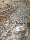 Looking down the line toward 341.8km, remaining flood water continues to flow from the ballast.