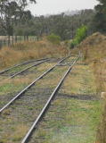 The view along the track looking north from Royalla station. The signals can be made out in the distance.