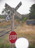 Another look at the railway crossing signage at the northern end of the Royalla platform, complete with lens flare. In the distance the track heads north towards Queanbeyan.