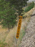 A caution 30 marker on the side of the track. It appears to have said 20 originally.