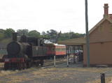 Steam engine 1307, plus a carriage and van in the background.